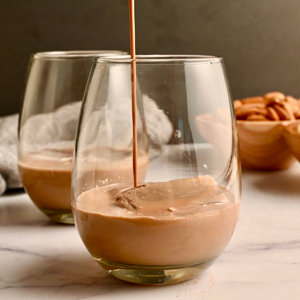 Dairy-free Irish coffee being poured into a short glass 